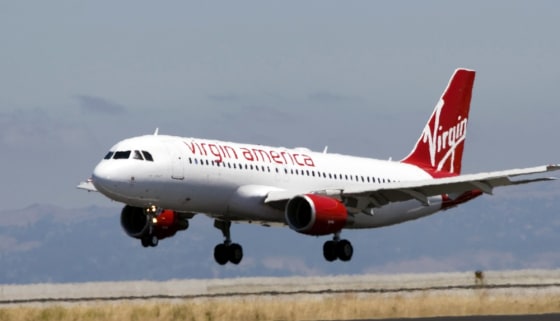 **FILE**In this Aug. 8, 2007 file photo provided by Virgin America, a Virgin America plane arrives at San Francisco International Airport from New York's John F. Kennedy International Airport. U.S. Transportation Secretary Mary Peters is scheduled to deliver a report to the president in mid-December, 2007, on the problem of airport delays. If she goes ahead with a plan to ease delays by capping the number of flights at Kennedy, it could make it harder for new carriers like Virgin America to expand in New York. (AP Photo/Virgin America, John Decker, File)